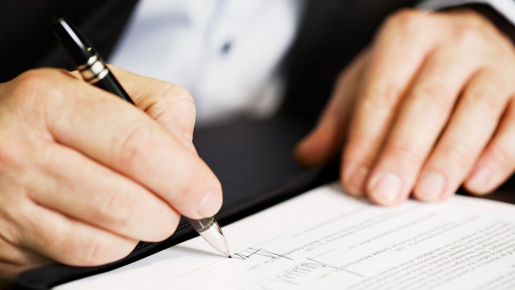 Business owner signing company documents